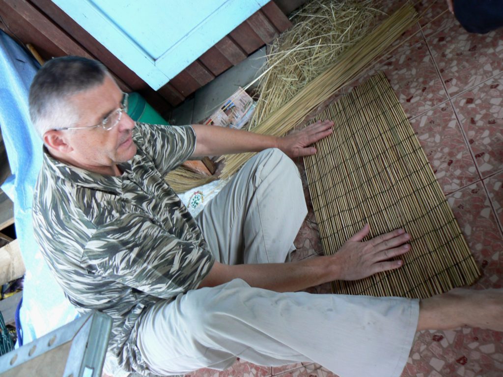 crafting a bamboo mat for a fish trap