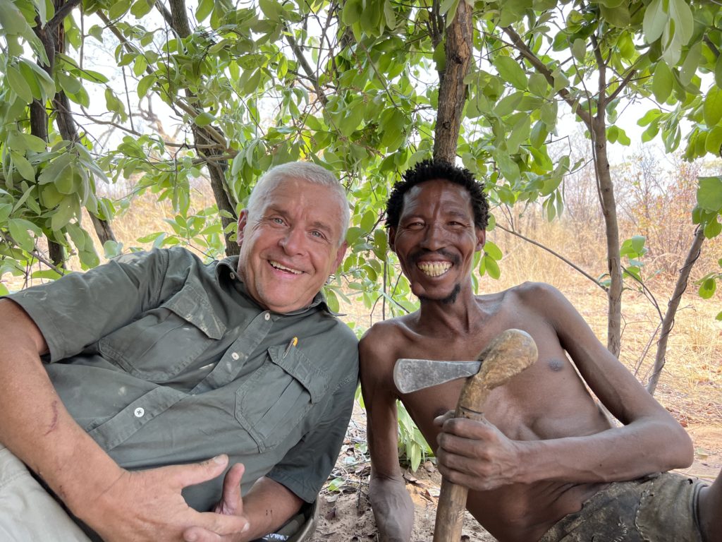 Author and bushman in a leaf hut shelter