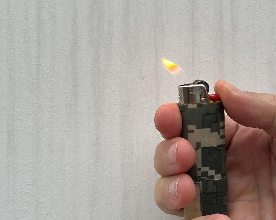 Testing wind direction with a fire lighter flame