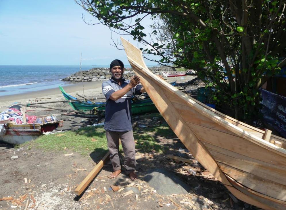 Boatbuilder and his fishing boat at Padang Beach