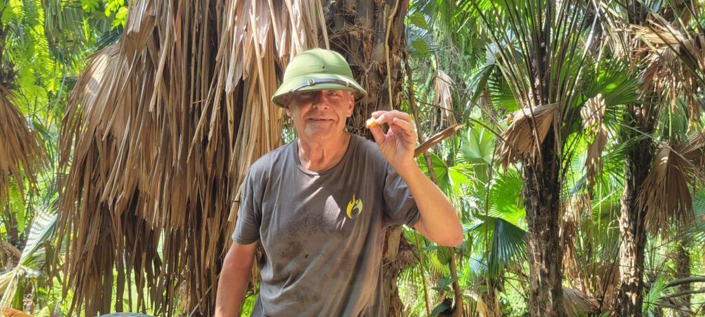 The author with a Sago worm in hand in Vietnam