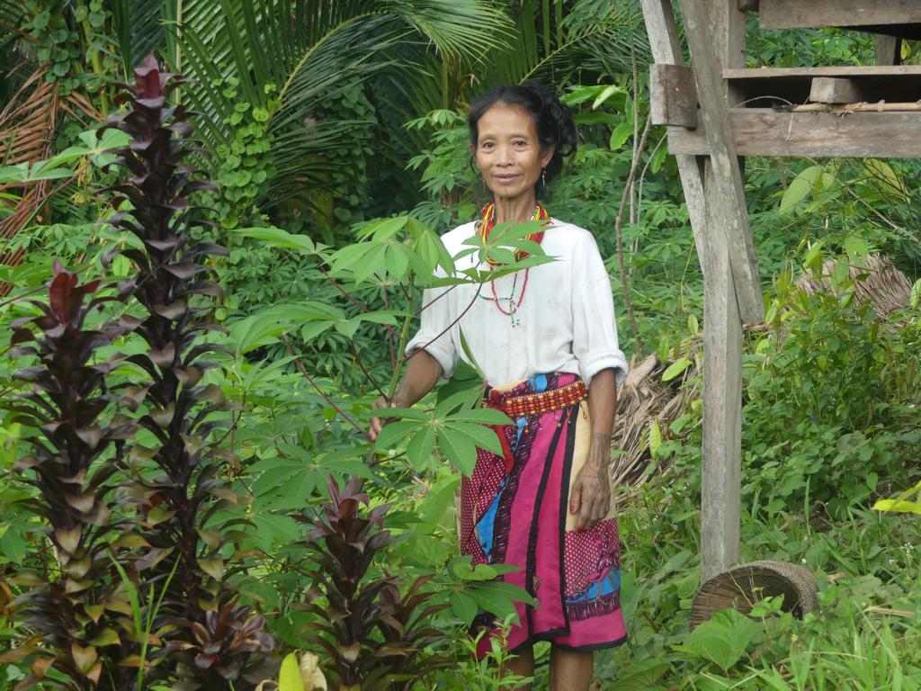 Mentawai woman in her garden around the uma