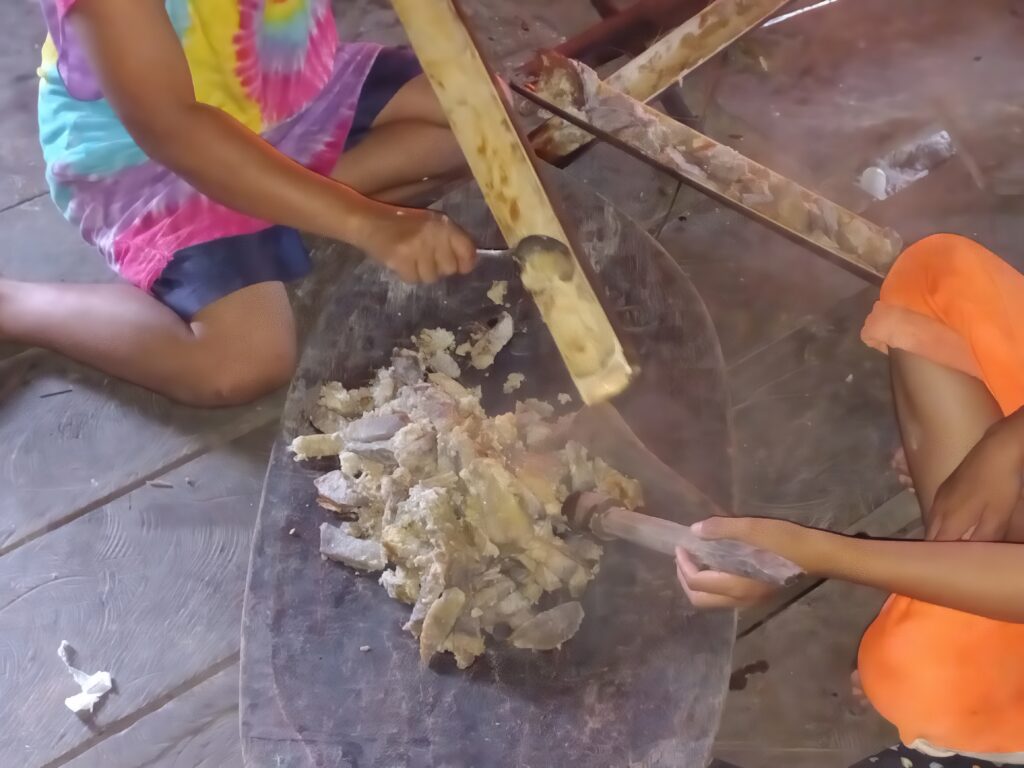 Smashing cooked taro roots and bananas