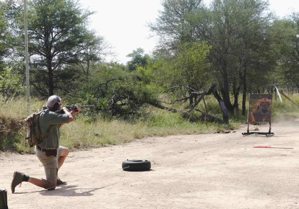 Kurt Hoelzl shooting on a charging lion target