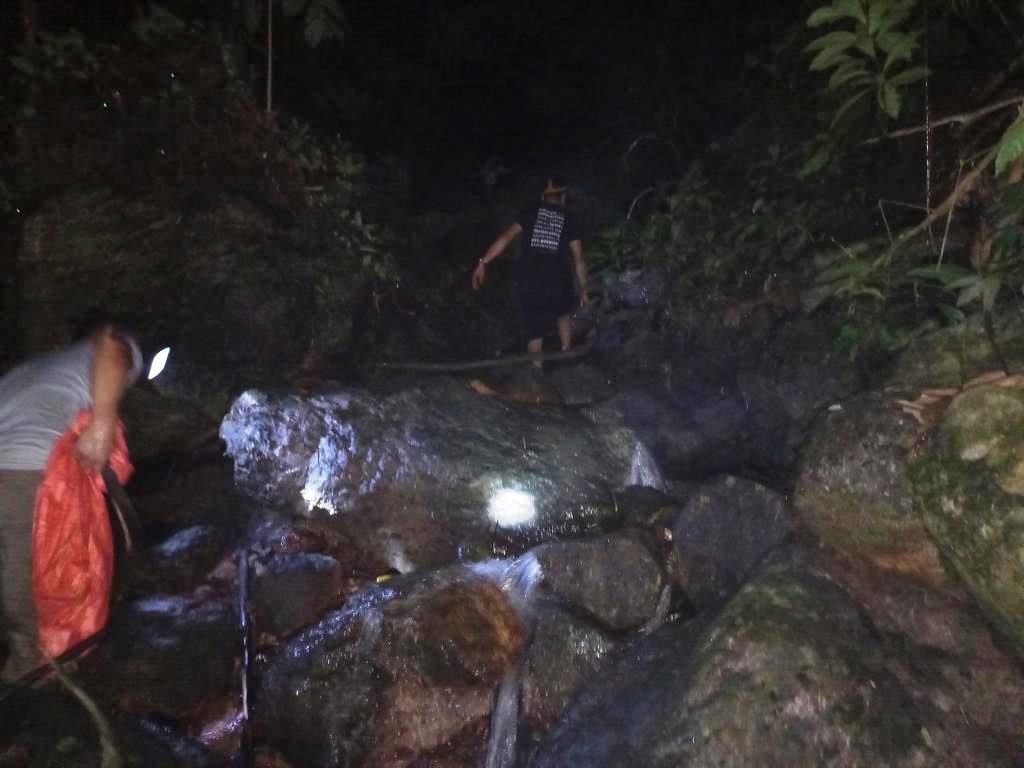 catching rock snails and mountain crabs on a stream in the limestone mountains in vietnam
