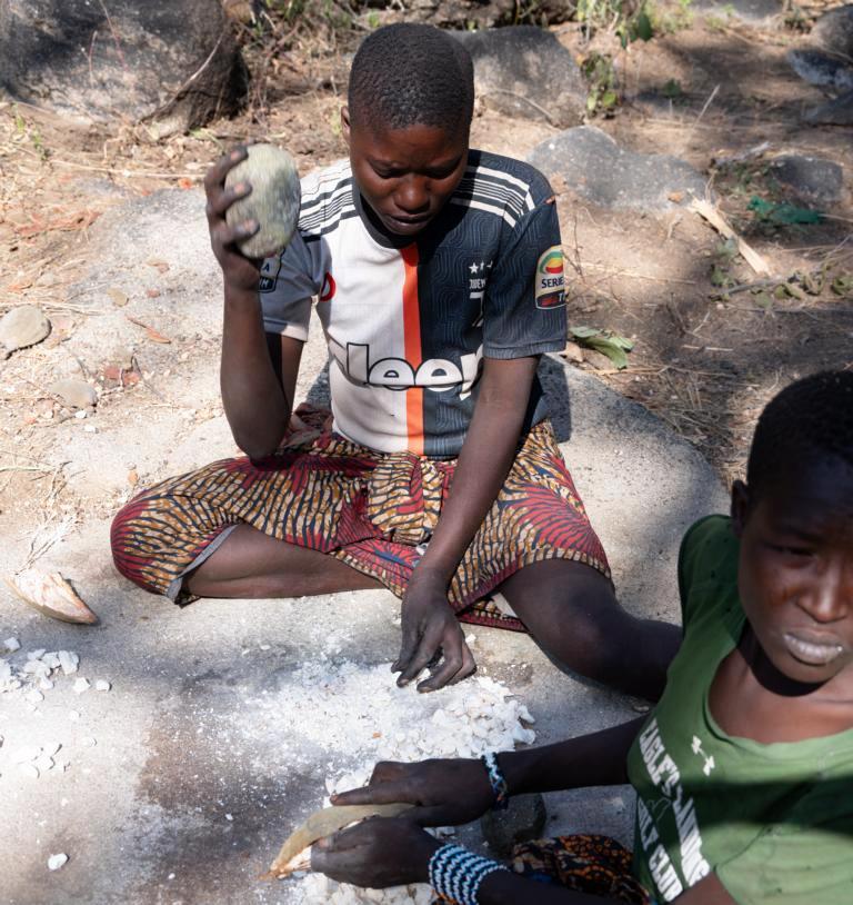 Pounding Baobab seeds and pulp