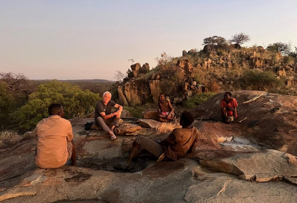 Kurt Hoelzl togehter with Hadza people in the sunset