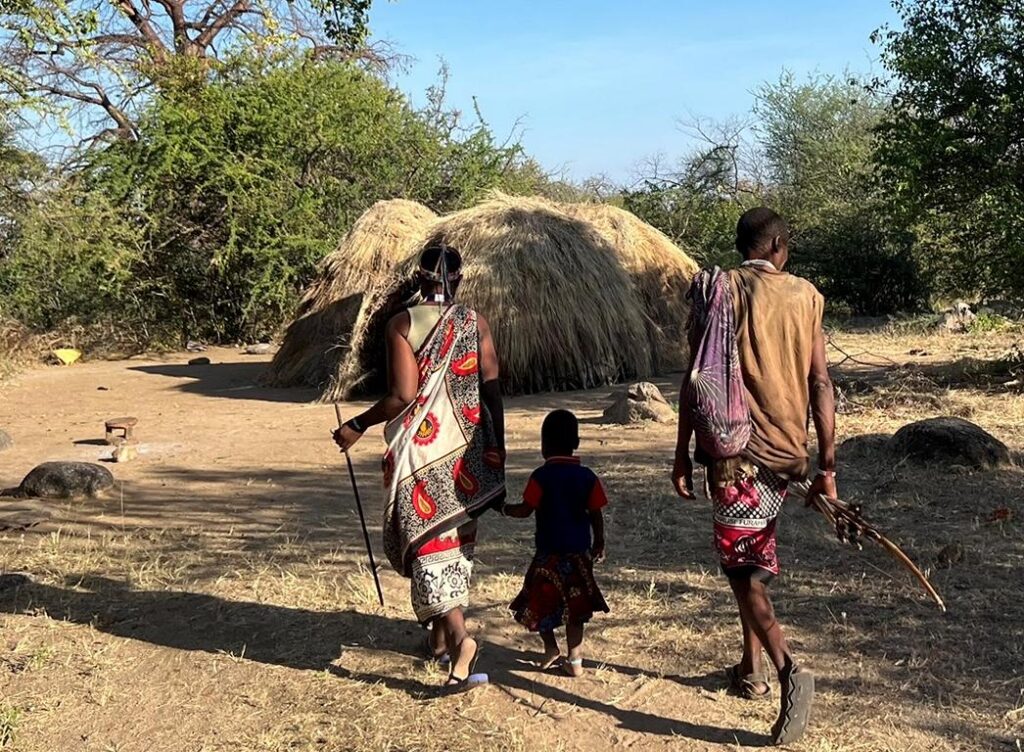 Old Hadza couple walking towards their hut