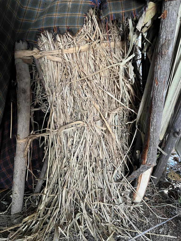 Separation wall in a Hadza hut