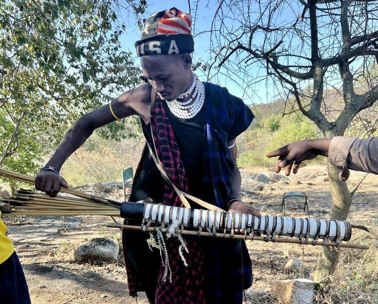 Datoga hunter takes out arrows from his quiver