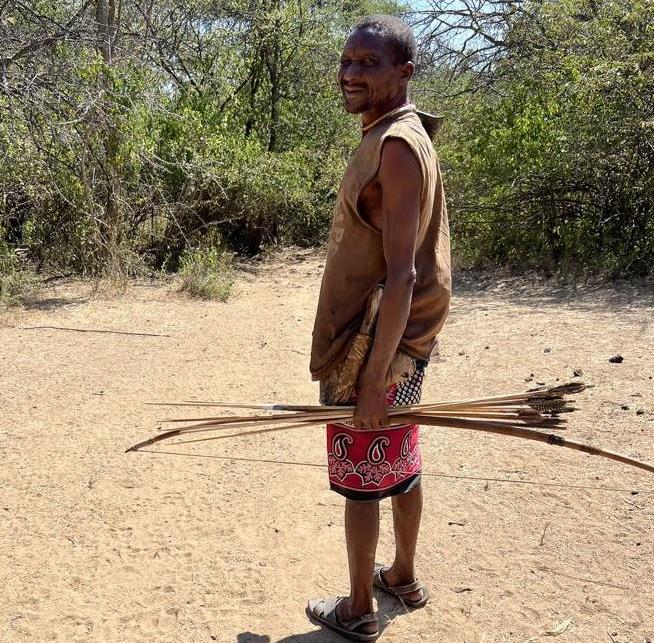 Hadza men always carry their bow and arrows with them