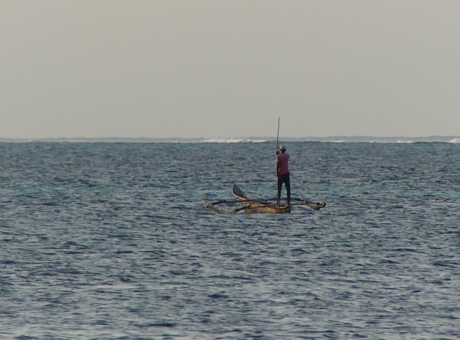 Poling a Ngalawa boat in a lagoon of Zanzibar