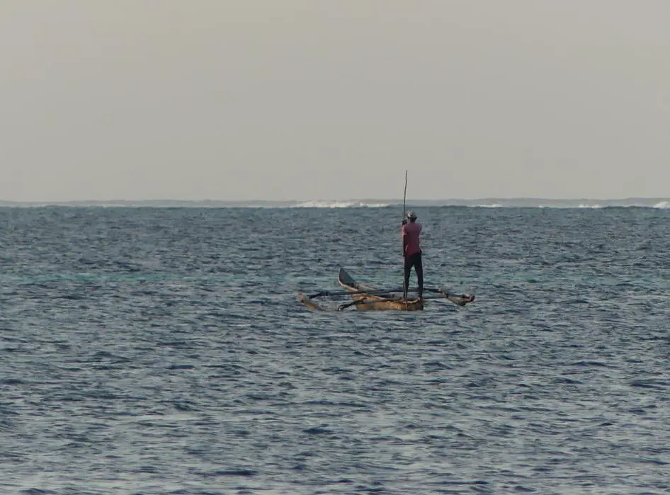 Poling a Ngalawa boat in a lagoon of Zanzibar