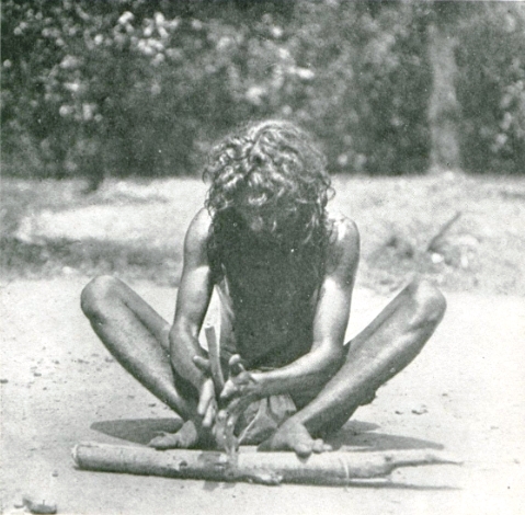 A Rock Vedda making fire with a "fire-drill" (1900)