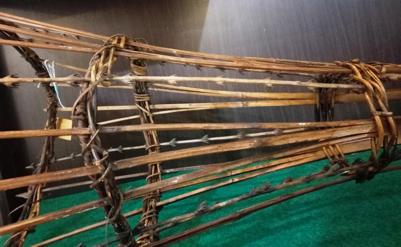 Woven bamboo fish trap with interwoven rattan flagella.