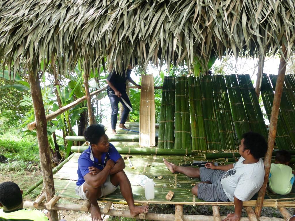 One man working, others resting