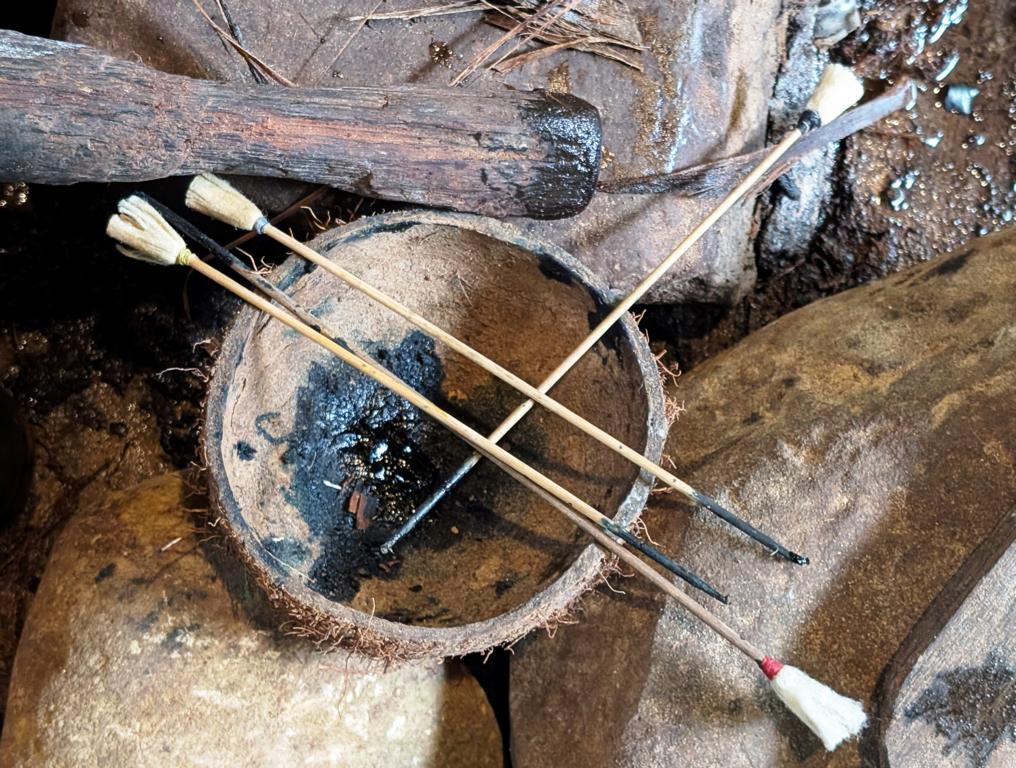 Poisoned Borneo blowpipe darts with string tail-ends.