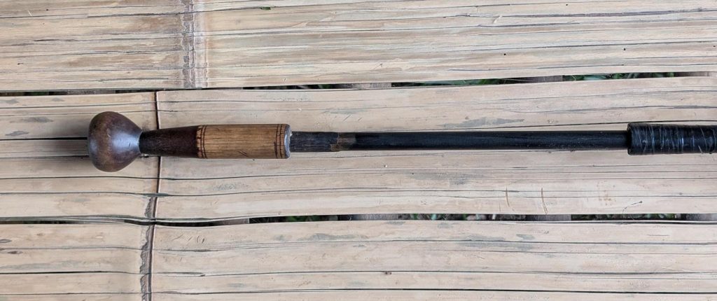 The protective sheath was partially retracted, revealing the black, smoked inner bamboo tube.