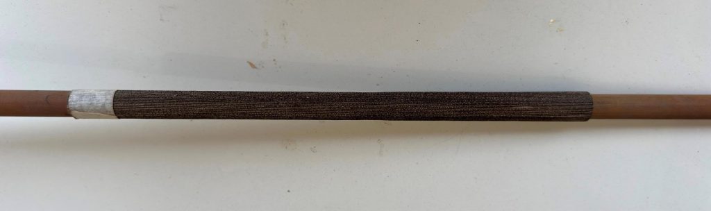 The Semai blowpipe inner tubes are connected by the sheath of an emerging palm frond.